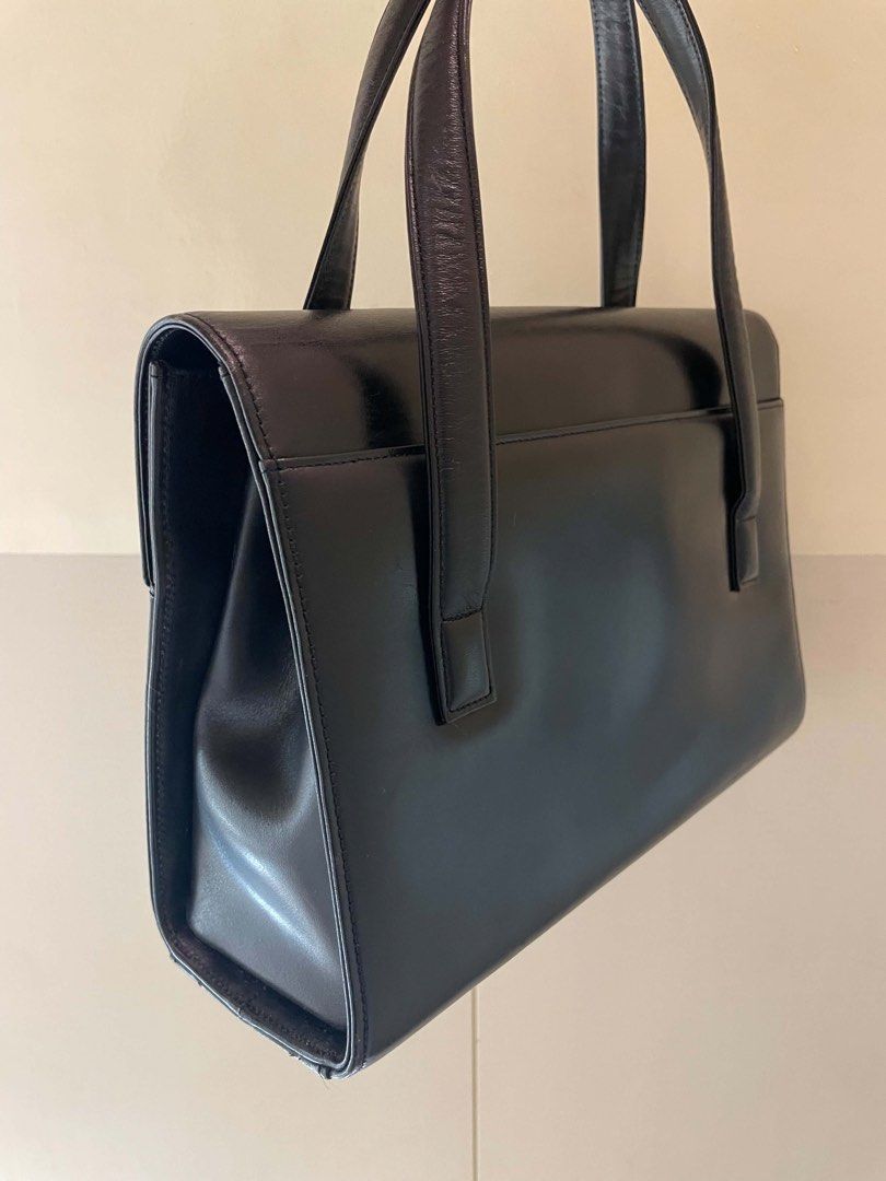 Givenchy Black Leather Handbag (Category: Luxury Bags & Wallets) located in Manila. Submitted by luxblocc (Listing ID 1453269234, Image 3). Description: - Classic black leather handbag - Iconic Givenchy 4G logo clasp - Top handle design - Interior zip pocket - Gold hardware details - Timeless piece for any collection - Great for daily use or special occasions.