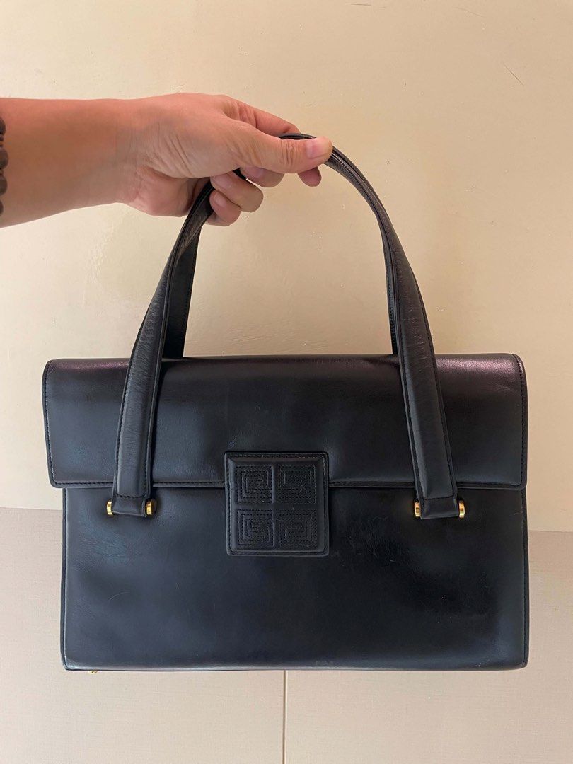 Givenchy Black Leather Handbag (Category: Luxury Bags & Wallets) located in Manila. Submitted by luxblocc (Listing ID 1453269234, Image 1). Description: - Classic black leather handbag - Iconic Givenchy 4G logo clasp - Top handle design - Interior zip pocket - Gold hardware details - Timeless piece for any collection - Great for daily use or special occasions.