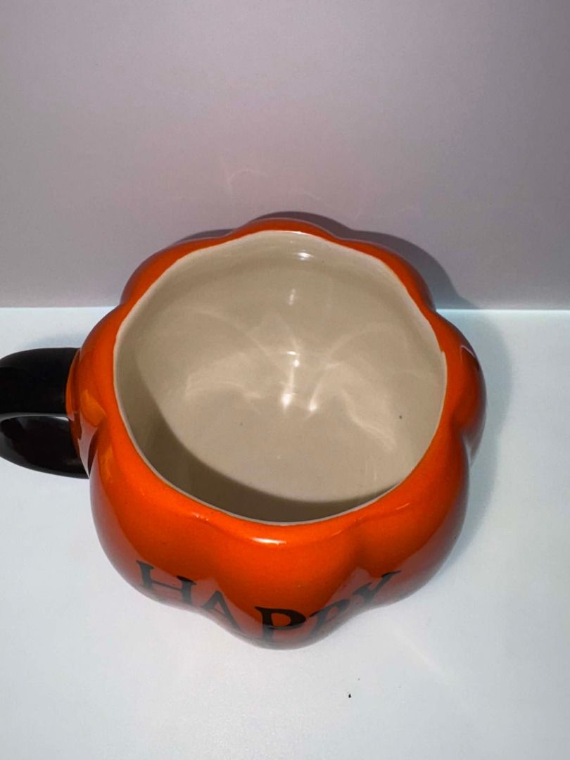 Happy Halloween Heavy Ceramic Pumpkin Mug (Category: Coffee & Tea Tableware) located in Caloocan City. Submitted by rabbithole2026 (Listing ID 1453359732, Image 2). Description: Heavyweight ceramic construction Pumpkin-shaped design "Happy Halloween" graphic Glossy orange finish Black handle Ideal for coffee, tea, cocoa, and fall décor.
