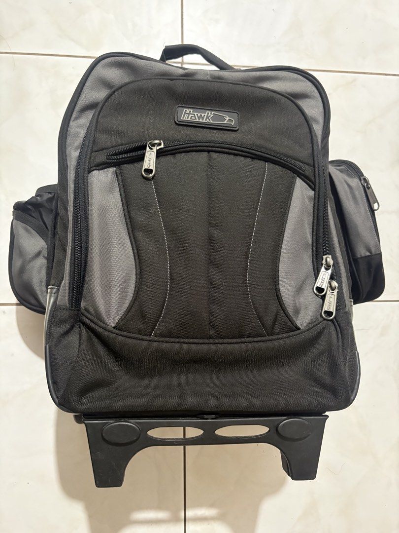 Hawk Rolling Backpack Luggage Bag (Category: Backpacks) located in Imus. Submitted by Erins_Box (Listing ID 1453262561, Image 1). Description: - Hawk rolling backpack - Color: Black and Grey - Features wheels and a retractable pull-up handle - Multiple compartments for organized storage - Includes side pockets - Ideal for school or travel - Zippers are in good working condition - Interior is clean.