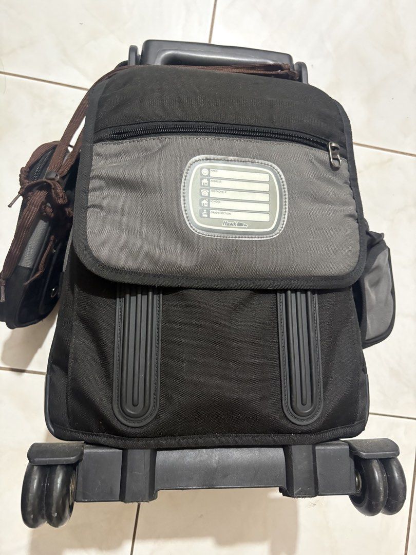 Hawk Rolling Backpack Luggage Bag (Category: Backpacks) located in Imus. Submitted by Erins_Box (Listing ID 1453262561, Image 3). Description: - Hawk rolling backpack - Color: Black and Grey - Features wheels and a retractable pull-up handle - Multiple compartments for organized storage - Includes side pockets - Ideal for school or travel - Zippers are in good working condition - Interior is clean.