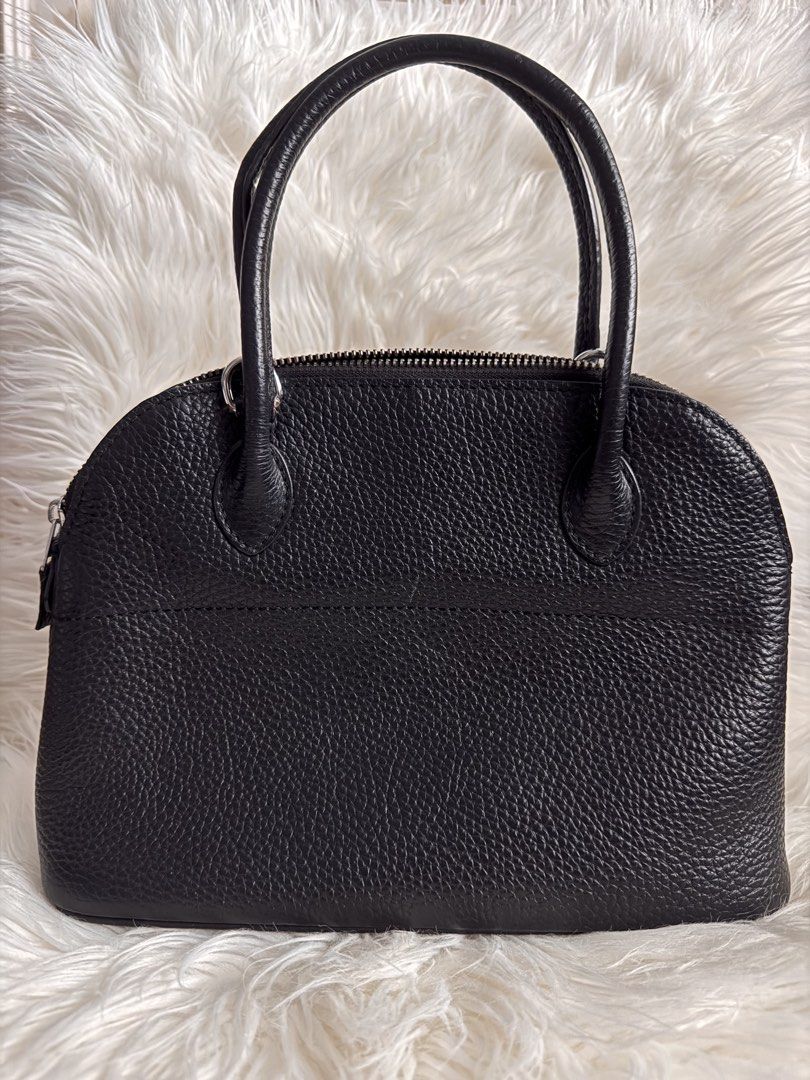 Hermes Black Leather Top Handle Bag (Category: Luxury Bags & Wallets) located in Pasay City. Submitted by minetochooseshop (Listing ID 1453247226, Image 2). Description: - Classic black leather handbag - Pebbled texture all over - Secure zipper closure - Interior slip pockets - Four protective metal feet on the bottom - Made in France - Timeless and elegant design.