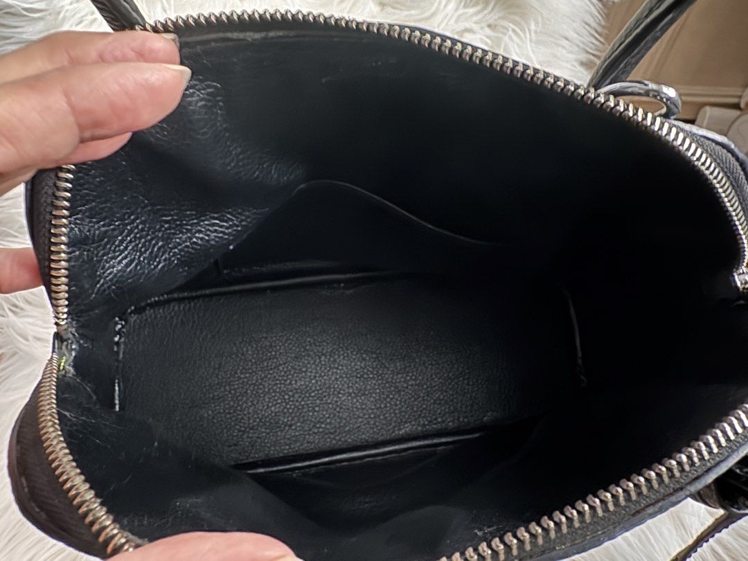 Hermes Black Leather Top Handle Bag (Category: Luxury Bags & Wallets) located in Pasay City. Submitted by minetochooseshop (Listing ID 1453247226, Image 3). Description: - Classic black leather handbag - Pebbled texture all over - Secure zipper closure - Interior slip pockets - Four protective metal feet on the bottom - Made in France - Timeless and elegant design.
