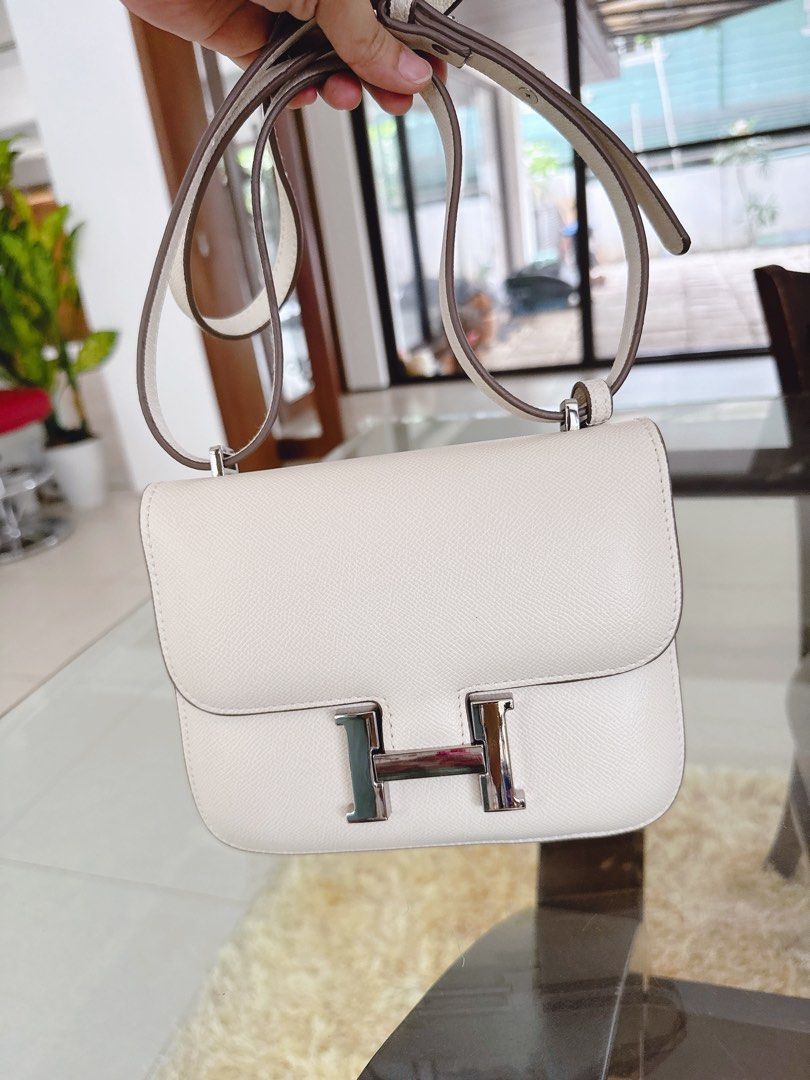 Hermes Constance Bag White Epsom Leather Silver Hardware (Category: Luxury Bags & Wallets) located in Makati City. Submitted by lovehobshop (Listing ID 1453423287, Image 2). Description: - Hermes Constance Bag inspired only - Material: Epsom Leather - Hardware: Silver Closure - Interior: Clean - Strap: Long strap for shoulder/crossbody wear - Style: Classic, versatile for daily use or special occasions Minimal sign of wear-very light stain on the