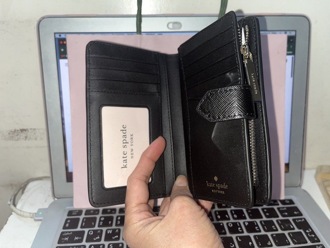 Kate Spade Bi-fold Wallet Black and Beige (Category: Luxury Bags & Wallets) located in Las Pinas. Submitted by shopperz (Listing ID 1453327277, Image 3). Description: - Brand: Original Kate Spade - Style: Bi-fold wallet - Color: Black and beige color block - Material: Saffiano leather - Closure: Snap closure - Interior: Card slots and zip pocket - Features: Great for organizing essentials, compact size - With paper bag.