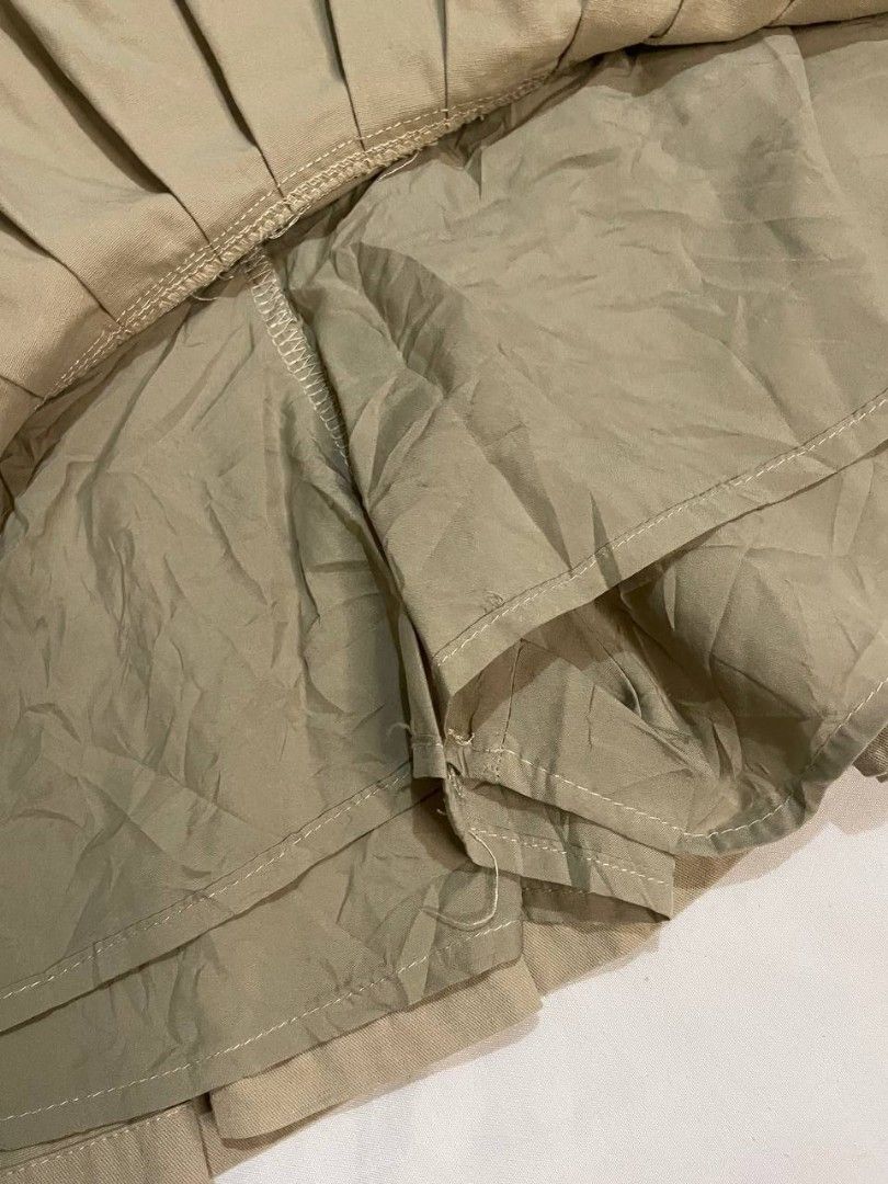 Khaki Denim Pleated Mini Skirt (Category: Skirts) located in Binan City. Submitted by declutterbyjwy (Listing ID 1453407413, Image 3). Description: waist: 24-25 | length: 14" - with inner short - soft denim fabric - good as new, never used - no flaws.