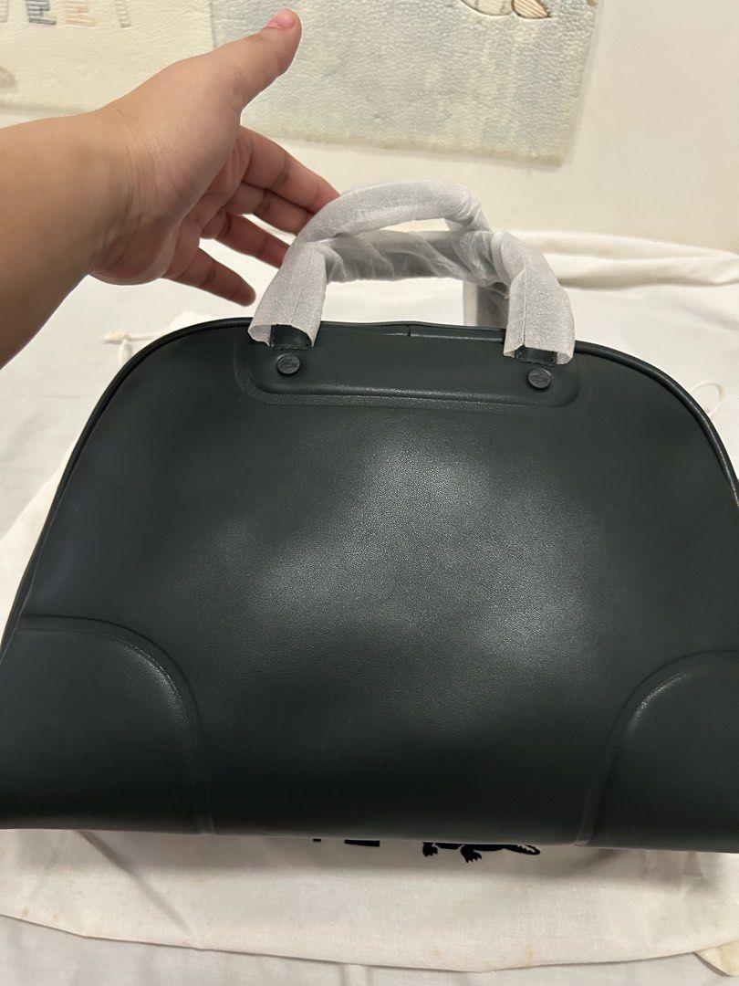 Lacoste Dark Green Leather Duffel Bag (Category: Luxury Bags & Wallets) located in Cebu City. Submitted by tagsglamor (Listing ID 1453281534, Image 2). Description: - Authentic dark green Lacoste duffel bag - Crafted from premium leather - Spacious main compartment - Convenient internal pockets for organization - Includes a detachable shoulder strap for versatile carrying - Comes with its original dust bag - Ideal for weekend trips or gym essenti