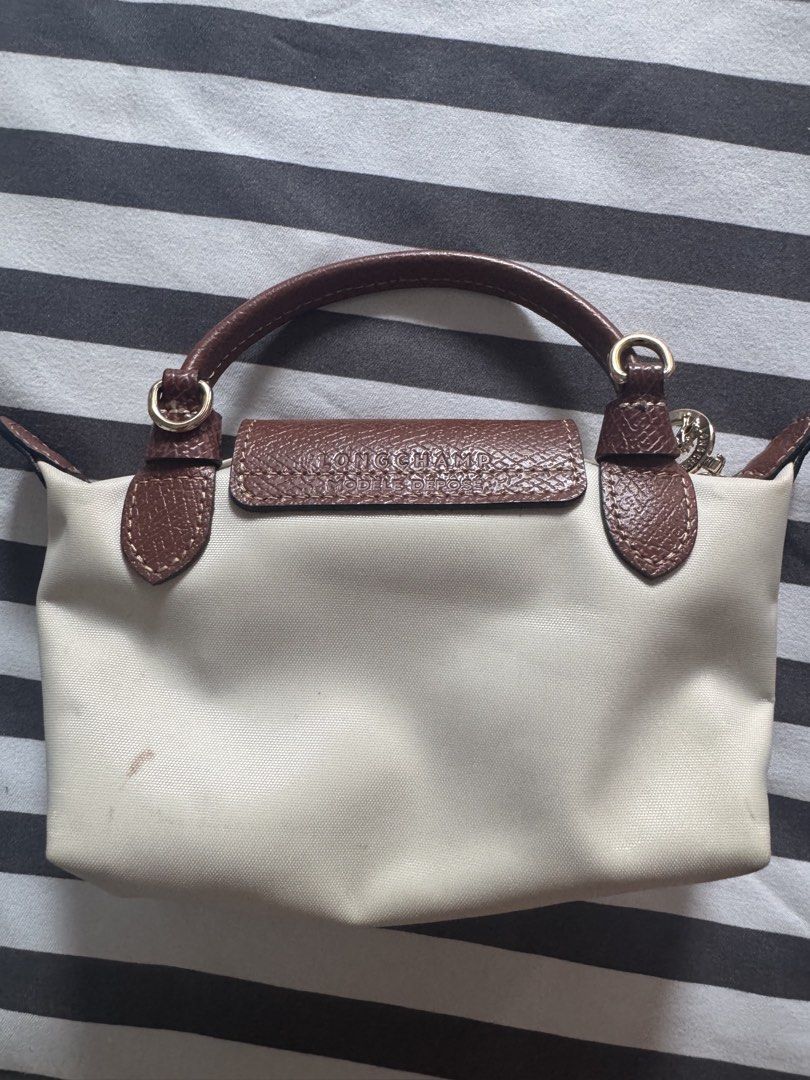 Longchamp Le Pliage Cuir Small Top Handle Bag Beige (Category: Luxury Bags & Wallets) located in Makati City. Submitted by kpmg111 (Listing ID 1453270065, Image 2). Description: Beige Longchamp Le Pliage Cuir small top Features brown leather trim and handle Secure snap button closure Comes with a small attached charm Minor faint marks on the canvas body Ideal for everyday use With strap Guaranteed authentic or money back 10x DM for inquiries.