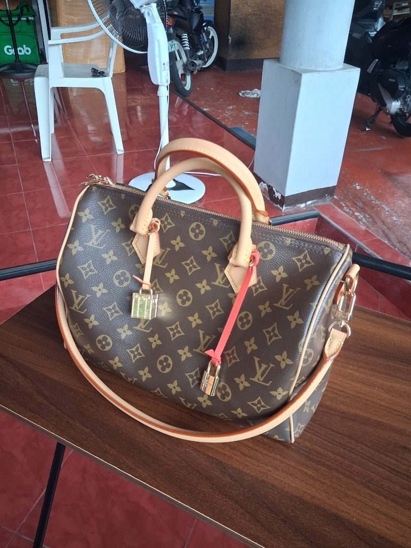 LV Speedy Soft 30 (Category: Luxury Bags & Wallets) located in Quezon City. Submitted by dhexyoblepias (Listing ID 1453081338, Image 2). Description: - Classic Louis Vuitton Speedy bag - Monogram canvas with tan leather trim and handles - Vibrant orange interior lining - Includes original lock, keys, and dust bag - Ideal for everyday use and travel.