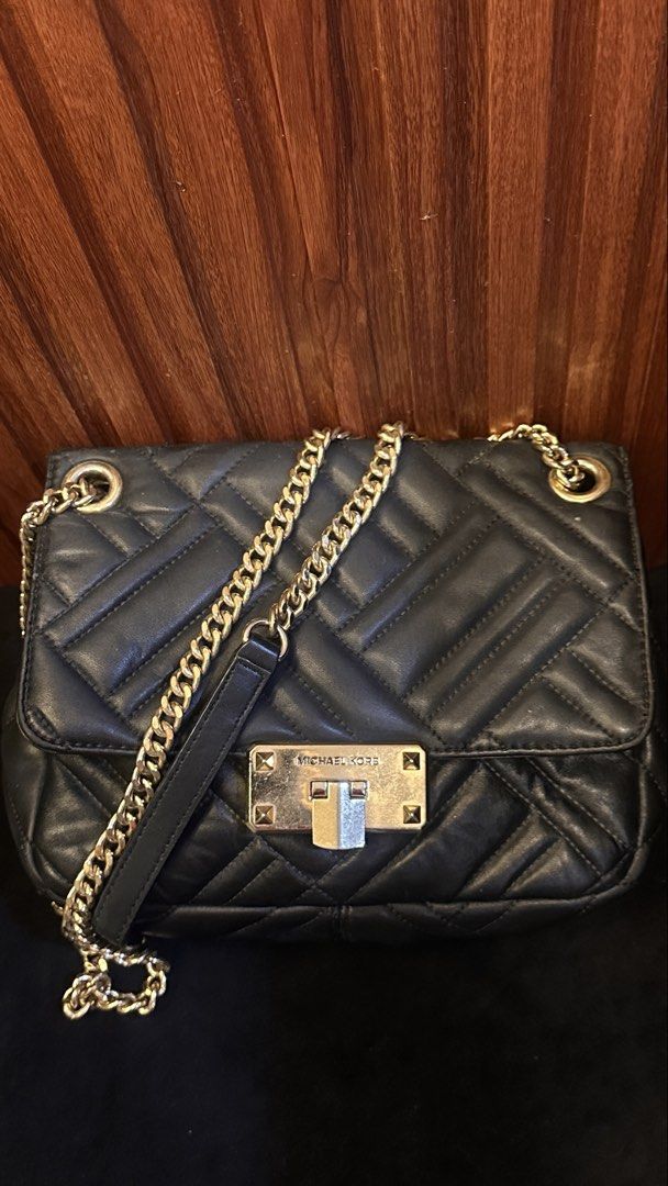 Michael Kors Black Quilted Leather Chain Shoulder Bag (Category: Luxury Bags & Wallets) located in Quezon City. Submitted by genie_in_a_closet (Listing ID 1453320153, Image 1). Description: - Pre-loved, Original - Black quilted leather shoulder bag - Gold chain strap - Secure turn-lock closure with Michael Kors branding - Versatile for day or night use - Spacious interior for essentials - Elegant gold hardware details - This is pre-loved, used bu