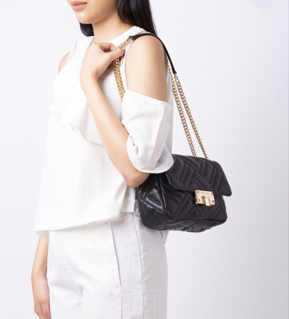 Michael Kors Black Quilted Leather Chain Shoulder Bag (Category: Luxury Bags & Wallets) located in Quezon City. Submitted by genie_in_a_closet (Listing ID 1453320153, Image 3). Description: - Pre-loved, Original - Black quilted leather shoulder bag - Gold chain strap - Secure turn-lock closure with Michael Kors branding - Versatile for day or night use - Spacious interior for essentials - Elegant gold hardware details - This is pre-loved, used bu