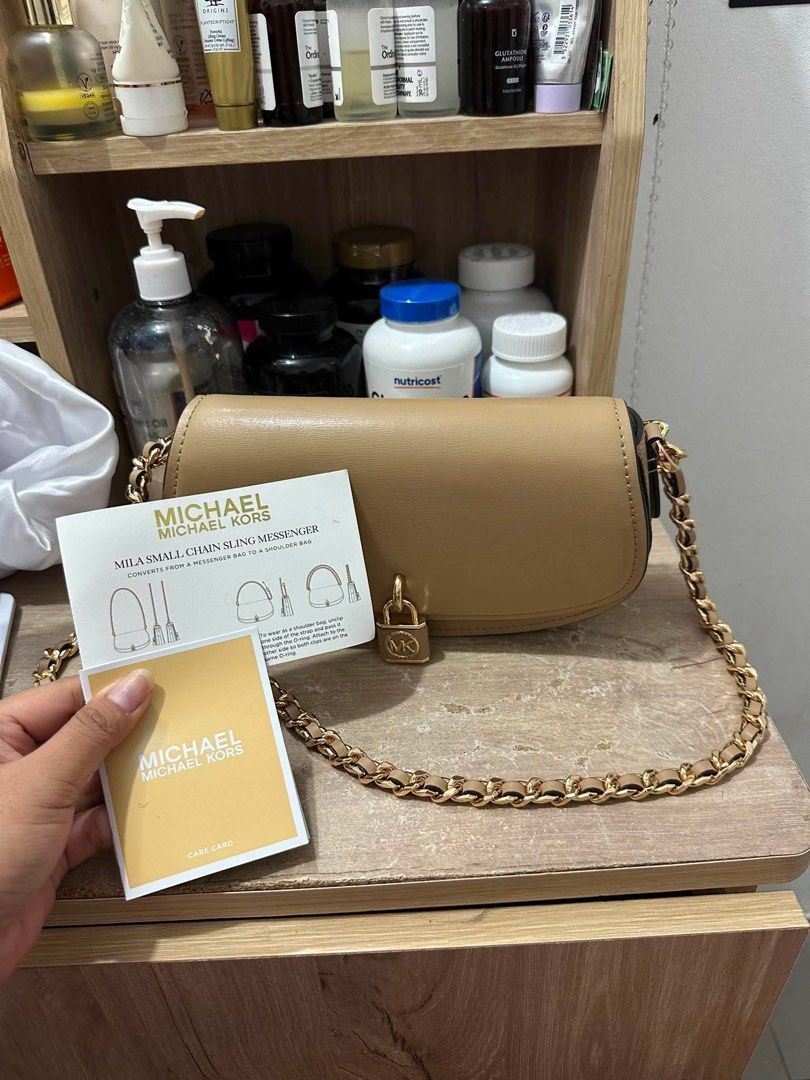 Michael Kors Mila Small Chain Messenger Bag (Category: Luxury Bags & Wallets) located in Caloocan City. Submitted by jilmaee (Listing ID 1453359521, Image 3). Description: - Authentic Michael Kors Mila small chain messenger bag - Beautiful tan color - Elegant gold hardware - Adjustable chain strap for versatile wear - Converts from crossbody to shoulder bag - Comes with original care card - Ideal for everyday use or evening outings.