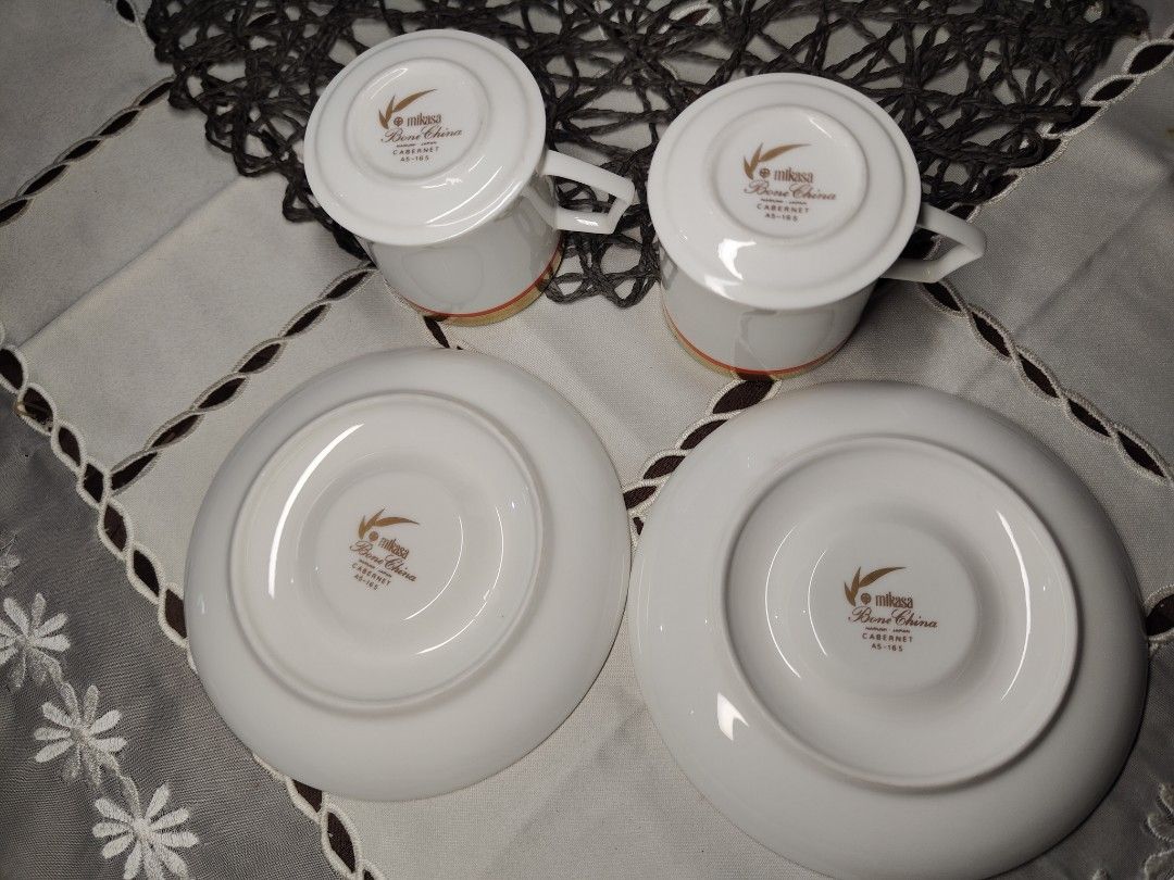 Mikasa Bone China Cabernet Coffee Cups and Saucers Set (Category: Coffee & Tea Tableware) located in Zamboanga. Submitted by lunavinum (Listing ID 1453342837, Image 2). Description: - Set of 2 Mikasa coffee cups and saucers - Bone China, Cabernet collection - Elegant white with gold and orange trim - Ideal for coffee or espresso - Perfect for hosting small gatherings or as a thoughtful gift - Clean and ready for a new home.