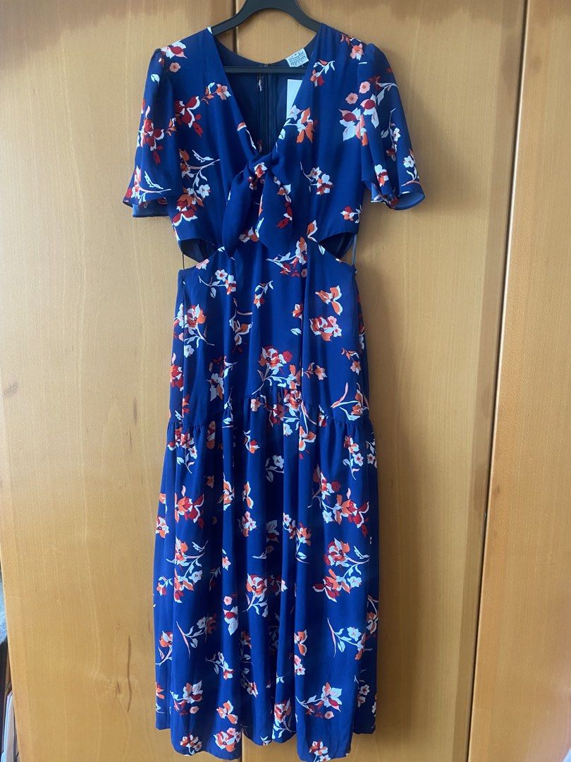 Missing Piece (Category: Dresses) located in Singapore. Submitted by esther21 (Listing ID 1453299541, Image 1). Description: - Brand: The Missing Piece - Size: S (UK 8 / EU 36 / US 4) PTP 41cm Waist 34cm Length 135cm - Color: Navy blue with floral print (red & orange accents) - Style: Midi dress with V-neck, tie-front detail, and waist cut-outs - Condition: Brand new with tags - Perfect for casual outings or events.