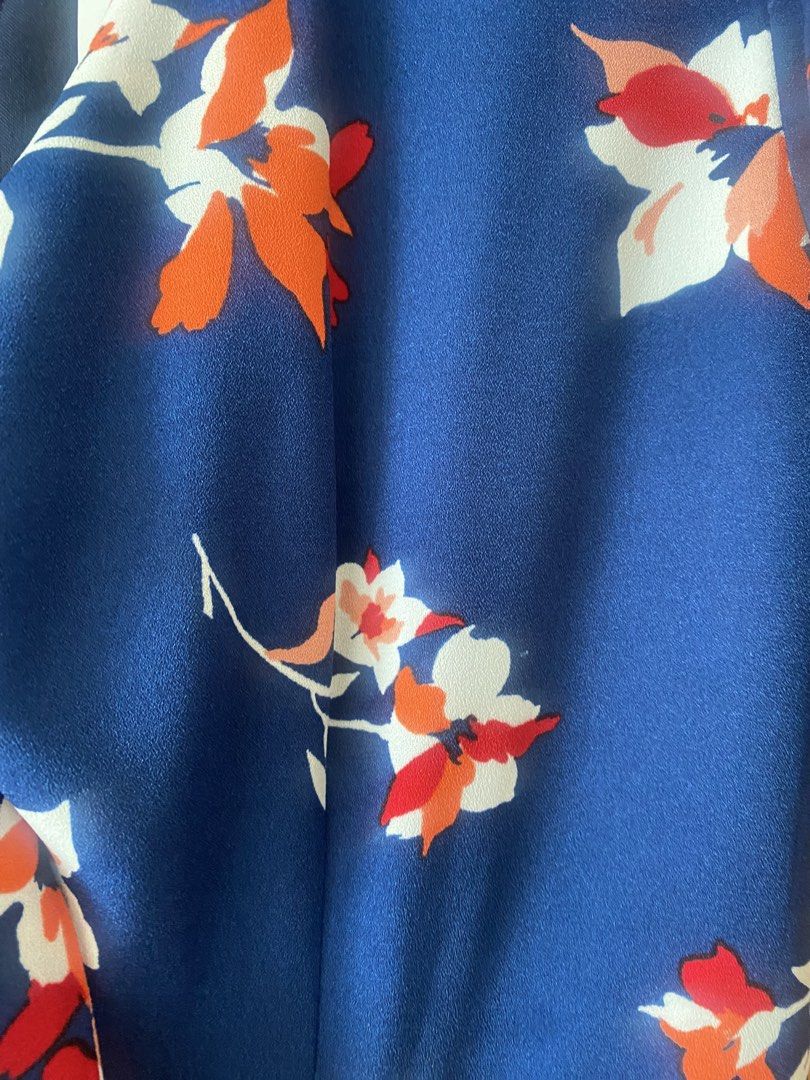 Missing Piece (Category: Dresses) located in Singapore. Submitted by esther21 (Listing ID 1453299541, Image 3). Description: - Brand: The Missing Piece - Size: S (UK 8 / EU 36 / US 4) PTP 41cm Waist 34cm Length 135cm - Color: Navy blue with floral print (red & orange accents) - Style: Midi dress with V-neck, tie-front detail, and waist cut-outs - Condition: Brand new with tags - Perfect for casual outings or events.