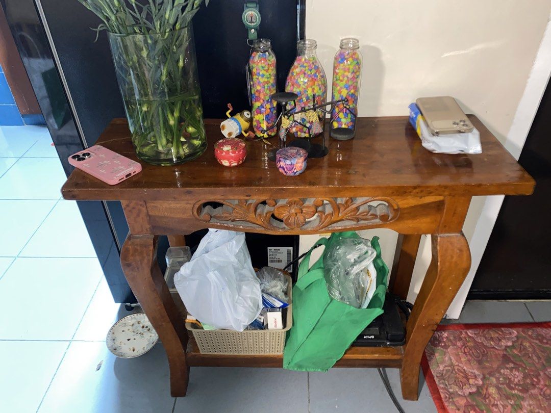 Nara Console Table (Category: Tables & Sets) located in Paranaque City. Submitted by coolaj (Listing ID 1453414126, Image 1). Description: - Solid wood construction - Beautiful carved detail on the front - Ample surface space for decor - Lower shelf for extra storage - Ideal for entryways or living rooms - Minor surface wear consistent with use.