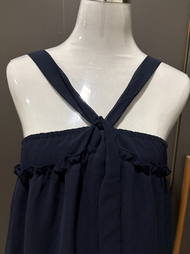 Navy Blue Ruffle Strap Dress with Tie Front (Category: Dresses) located in Manila. Submitted by roseannn_ (Listing ID 1453263645, Image 2). Description: - Navy blue dress - Ruffle trim along the bust - Criss-cross straps that tie at the front - Subtle textured fabric - Flowy and relaxed silhouette - Ideal for casual outings or beach days.