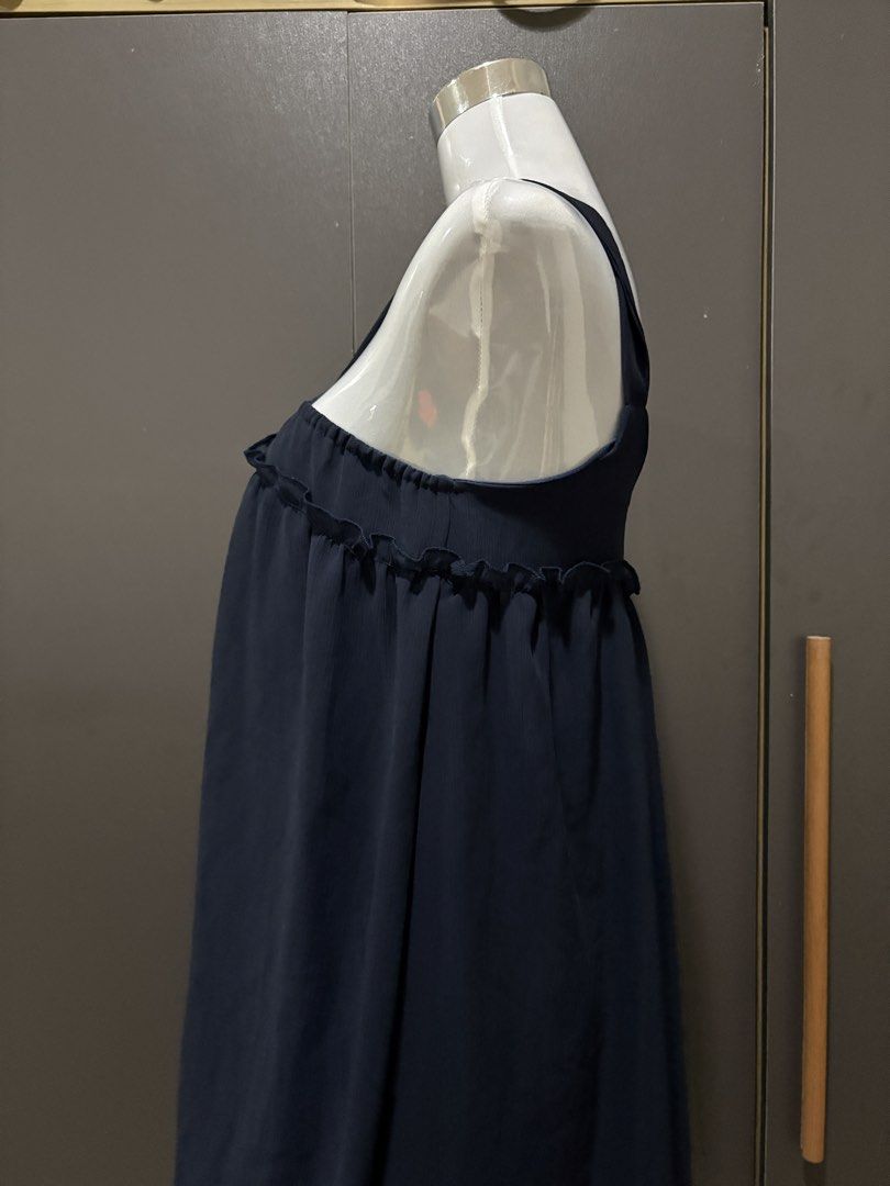 Navy Blue Ruffle Strap Dress with Tie Front (Category: Dresses) located in Manila. Submitted by roseannn_ (Listing ID 1453263645, Image 3). Description: - Navy blue dress - Ruffle trim along the bust - Criss-cross straps that tie at the front - Subtle textured fabric - Flowy and relaxed silhouette - Ideal for casual outings or beach days.