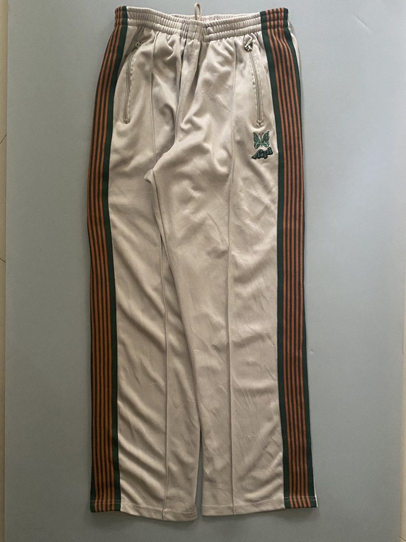NEEDLES X AIPL (Category: Joggers) located in Angeles City. Submitted by good_catchv3 (Listing ID 1453257205, Image 1). Description: Needles x AIPL track pants in beige with a green and orange side stripe. WAISTLINE FREE SIZE 30-38 LENGTH 39.5 LEG OPEN 10.