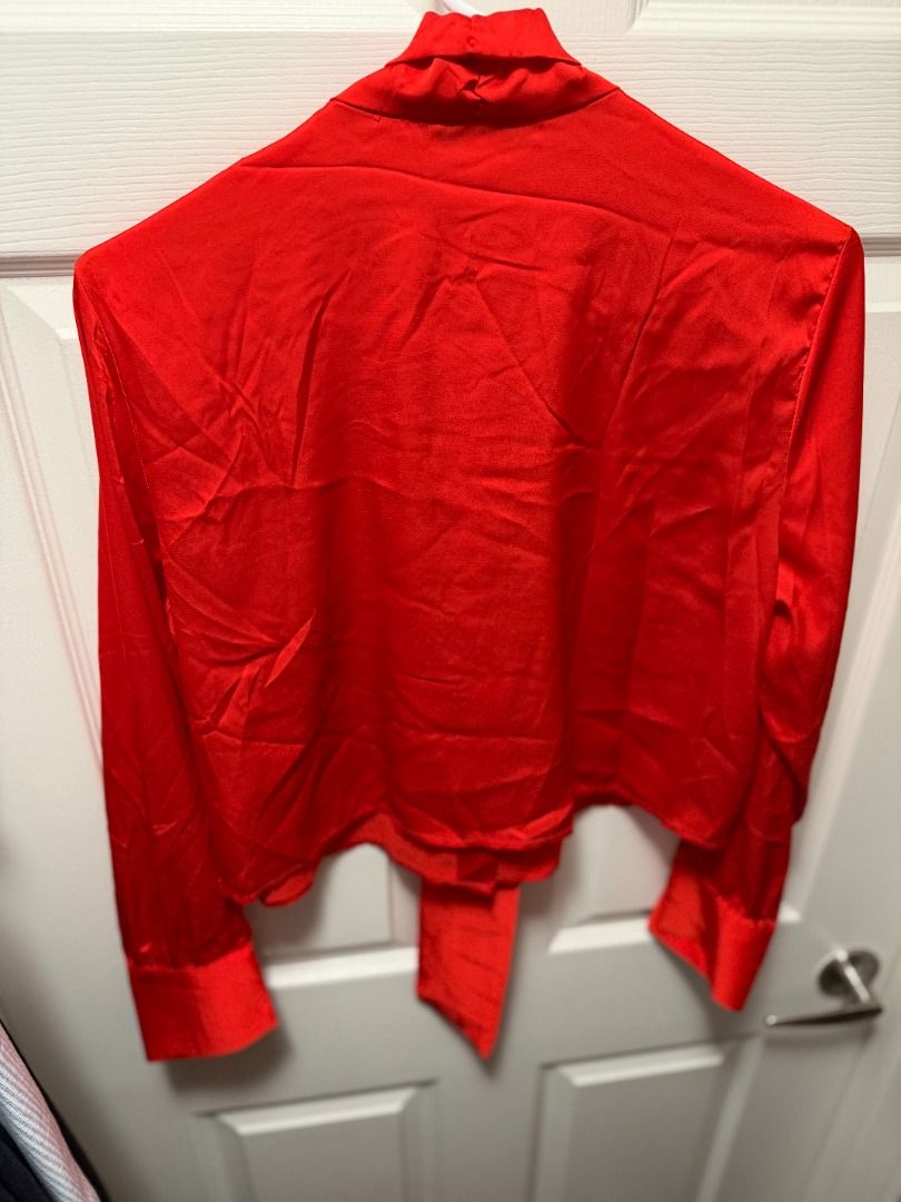 Nine West Red Long Sleeve Bow Blouse (Category: Blouses) located in Quezon City. Submitted by chryxanthemum (Listing ID 1453235910, Image 3). Description: - Nine West satin red long sleeve blouse - Sizes: Small (S),Medium (M) & Large (L) - Chic tie-neck detail - Slightly cropped fit - bottom of blouse sits right at the waistline. - Gold button-front closure - Long sleeves with statement cuffs, gold buttons - Perfect for dressing up or down, ideal