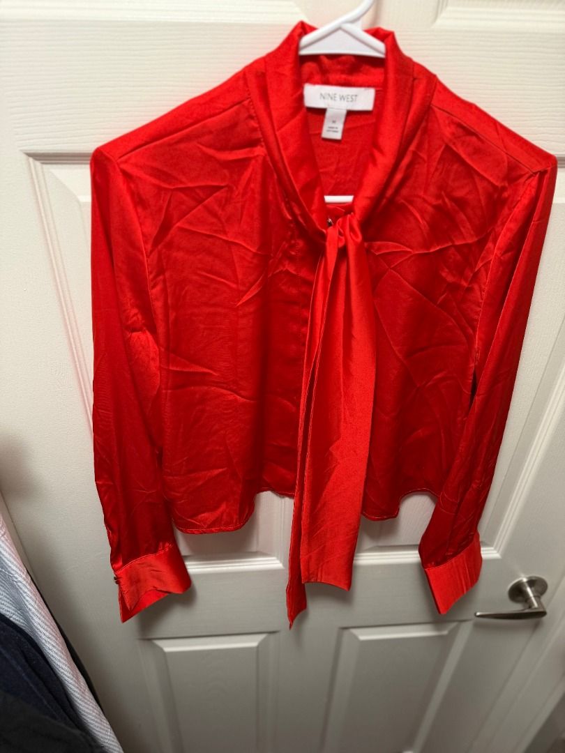 Nine West Red Long Sleeve Bow Blouse (Category: Blouses) located in Quezon City. Submitted by chryxanthemum (Listing ID 1453235910, Image 2). Description: - Nine West satin red long sleeve blouse - Sizes: Small (S),Medium (M) & Large (L) - Chic tie-neck detail - Slightly cropped fit - bottom of blouse sits right at the waistline. - Gold button-front closure - Long sleeves with statement cuffs, gold buttons - Perfect for dressing up or down, ideal