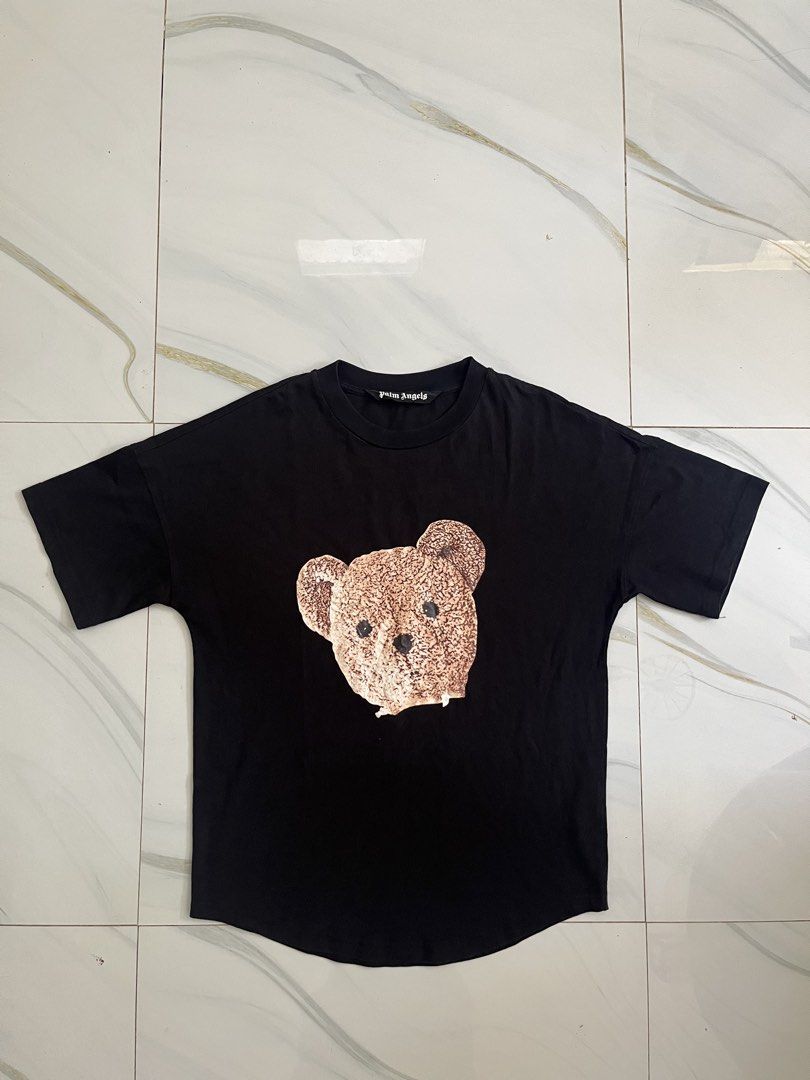 Palm Angels Black Bear Print T-Shirt (Category: Tshirts & Polo Shirts ) located in Aloran. Submitted by alrodferna18731 (Listing ID 1453322733, Image 1). Description: - Iconic Palm Angels teddy bear graphic on the front - Palm Angels text logo across the back - Classic short sleeves and crew neck design - Ideal for stylish, casual everyday wear - Genuine Palm Angels apparel.