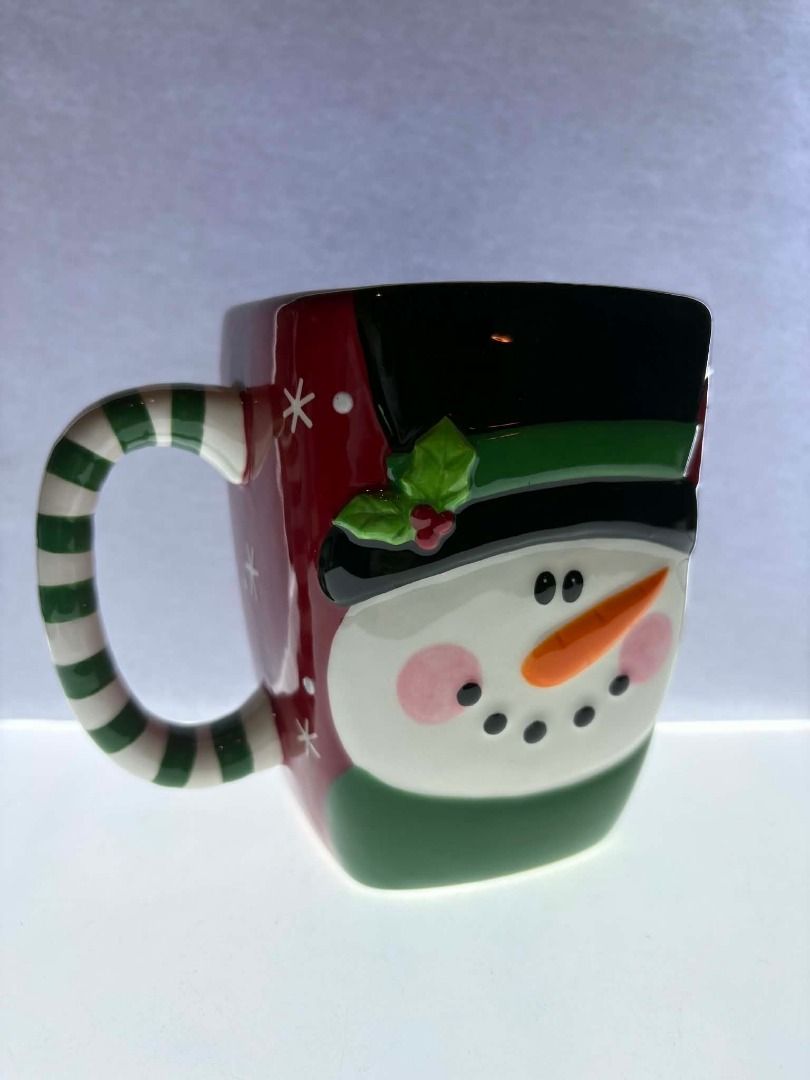 Personal Creations Embossed Snowman Mug (Category: Coffee & Tea Tableware) located in Caloocan City. Submitted by rabbithole2026 (Listing ID 1453391272, Image 2). Description: Festive and eye-catching large ceramic mug featuring an embossed 3D snowman face with raised details, rosy cheeks, carrot nose, black top hat, and holly accents. The oversized square shape and striped green-and-white handle make it perfect for coffee, tea, hot chocolate, so