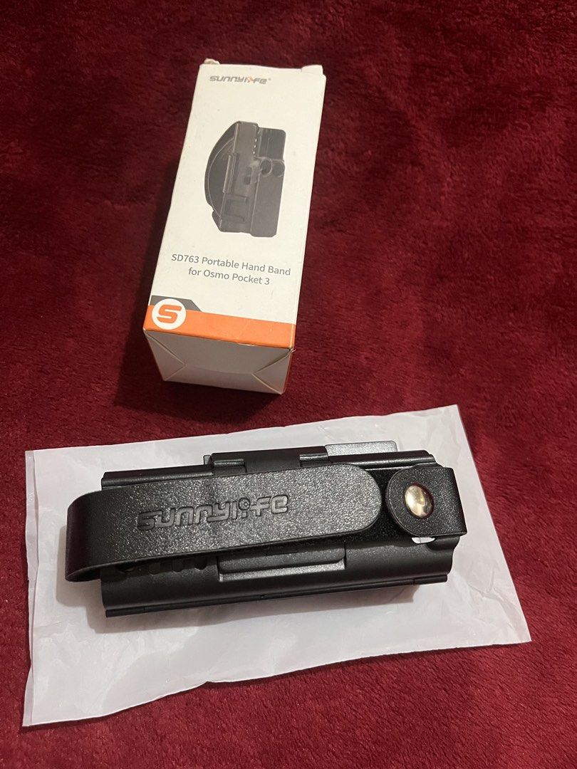 Portable Hand Band for Osmo Pocket 3 (Category: Other Accessories) located in La Trinidad. Submitted by whatnotcollections (Listing ID 1453267620, Image 2). Description: Specifications: - Brand: Sunnylife - Product Name: Portable Anti-Drop Hand Strap + Extension Handle Kit - Compatibility: For DJI Osmo Pocket 4 / 3 - Material: Plastic + Leather Features a portable hand strap that provides a comfortable and secure grip for safe shooting. You can e