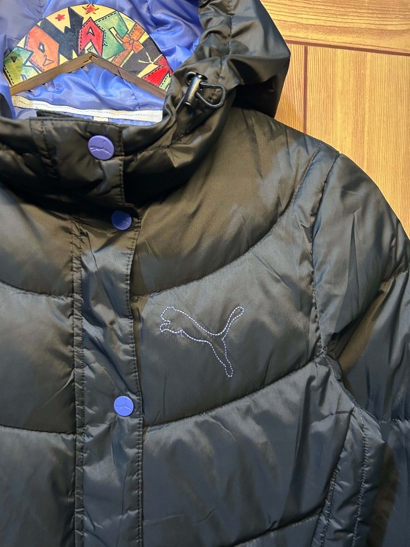 Puma Puffer Jacket (Category: Coats, Jackets and Outerwear) located in Manila. Submitted by zerowastethriftco. (Listing ID 1453411445, Image 2). Description: This is a detailed description of the black Puma puffer jacket: Design & Construction Color: The primary exterior color is a matte black. Quilting: Features a curved, chevron-style baffle pattern on the torso and horizontal stitching along the sleeves. Hood: It comes with an attached, insula