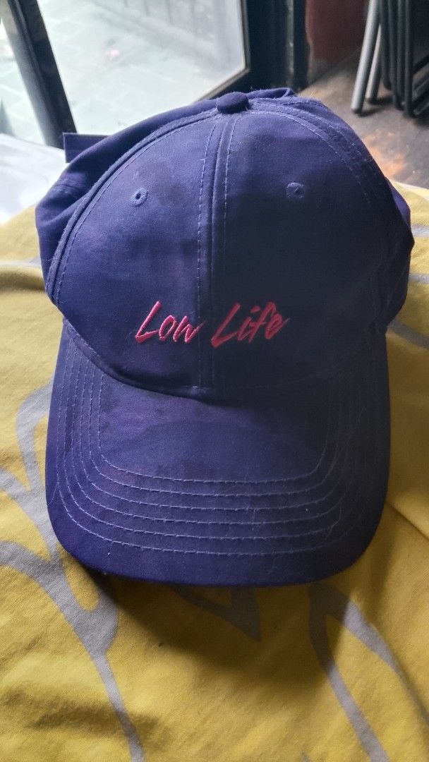 Purple Cap with "Low Life" Embroidery (Category: Caps & Hats) located in Valenzuela. Submitted by icebox28 (Listing ID 1453305118, Image 2). Description: - Purple baseball cap - Features "Low Life" embroidery in pink - Simple, casual design - Adjustable strap for a comfortable fit - One size fits most.