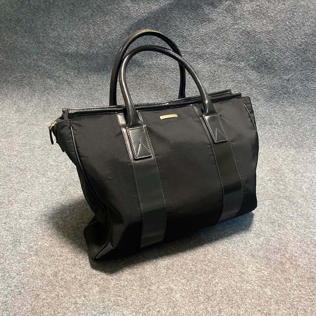 Salvatore Ferragamo Black Nylon Leather Bag (Category: Luxury Bags & Wallets) located in Cordova. Submitted by aux.archive (Listing ID 1453404855, Image 1). Description: This black nylon Salvatore Ferragamo handbag features leather handles and a subtle gold-toned brand plaque Large can fit files and laptop Great condition 8000 shipped.