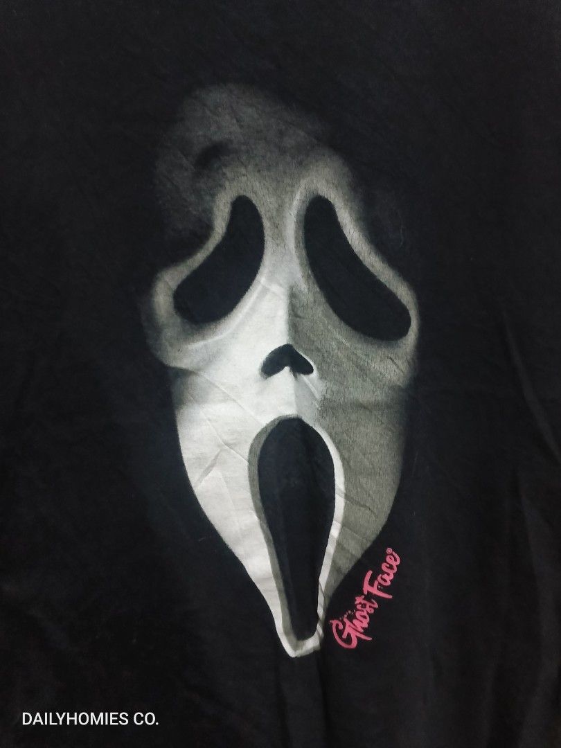 Scream Ghost Face Tee Size ( M ) (Category: Tshirts & Polo Shirts ) located in Manila. Submitted by dailyhomiescollection (Listing ID 1453258230, Image 2). Description: The "Scream's Ghost Face Tee" is a black T-shirt featuring a graphic print of the iconic Ghost Face character from the Halloween Horror Scream Movies. Made from a cotton blend material, this crew neck shirt has short sleeves and a regular fit in size L. It is machine washable and 