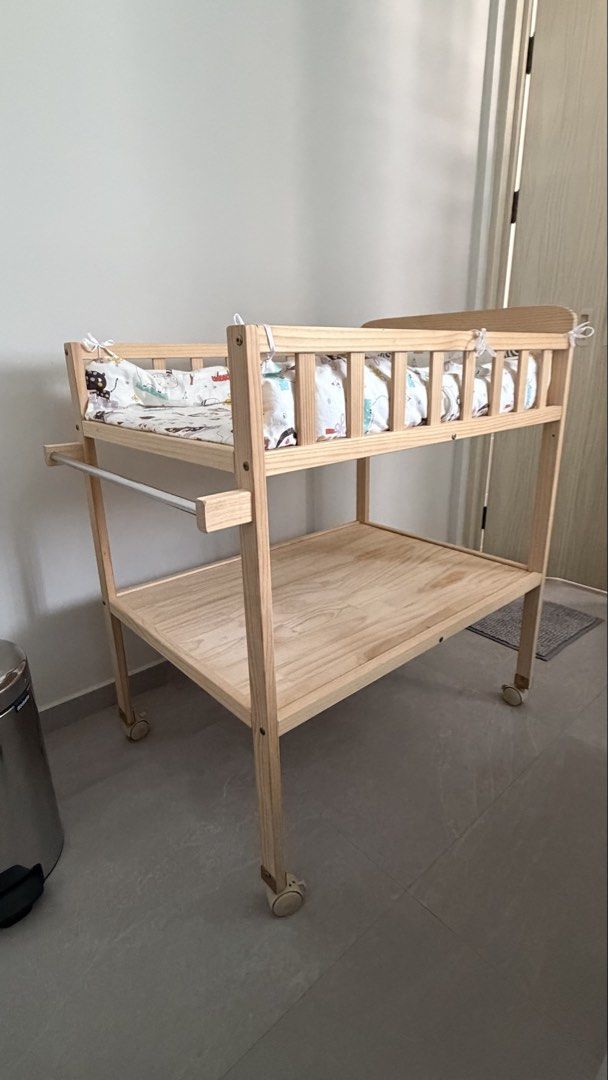 Solid Wood Changing Table (Category: Changing Tables & Stations) located in Singapore. Submitted by _lessismore (Listing ID 1453308041, Image 3). Description: Simple changing table with pad. perfect height, stable countertop, soft odorless pad, large easy-access storage for diapers and wipes, plus a towel bar. Lucky Baby rubber sheet fits the table perfectly (not included)..