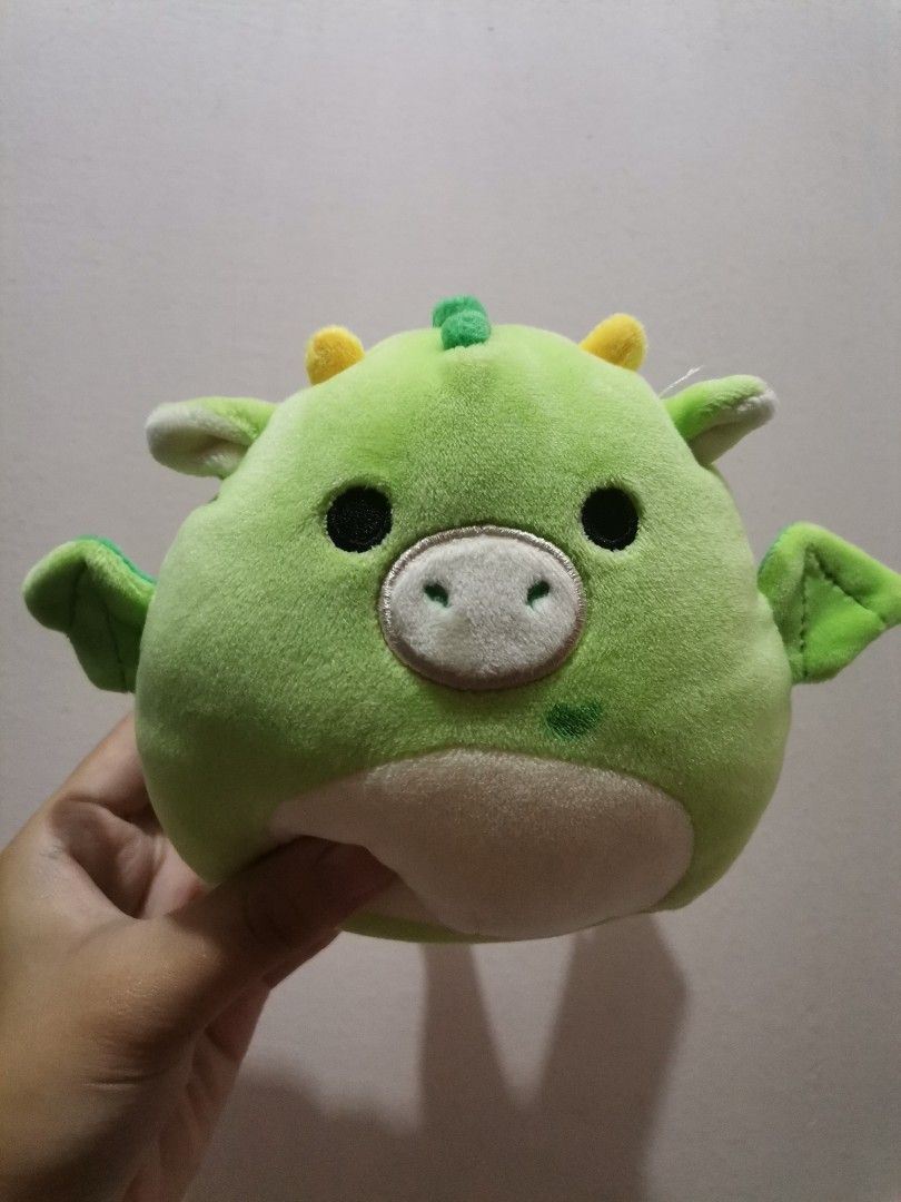 Squishmallows Green Dragon Plush Toy (Category: Plushies & Soft Toys) located in Makati City. Submitted by kookybearsstuff (Listing ID 1453333687, Image 1). Description: - Adorable green dragon plush toy from Squishmallows. - Super soft and squishy, ideal for hugs. - Features cute little wings and yellow horns. - Perfectly sized for children. - A must-have addition to any Squishmallow collection!.
