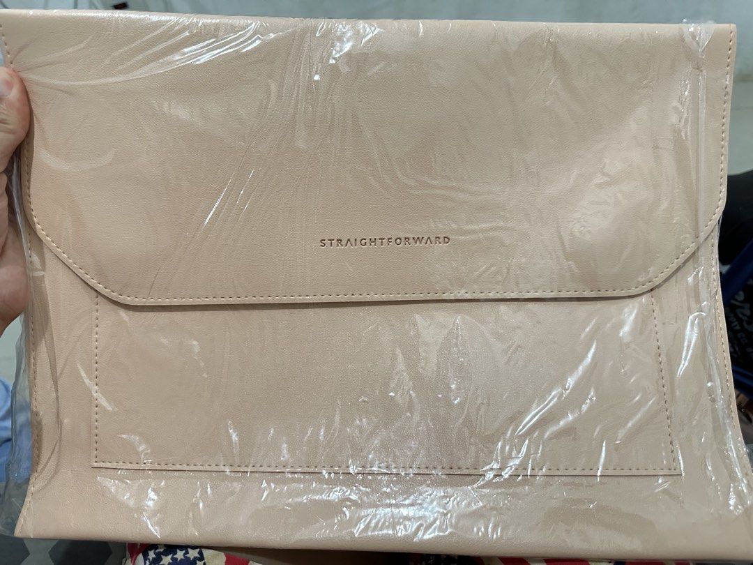 Straightforward Beige Leather Laptop Sleeve (Category: Laptop Bags & Sleeves) located in Manila. Submitted by er3h24 (Listing ID 1453284978, Image 1). Description: - Beige laptop sleeve from Straightforward - Features a flap closure - Includes a front pocket - Still in original plastic packaging - Ideal for protecting your laptop while on the go.