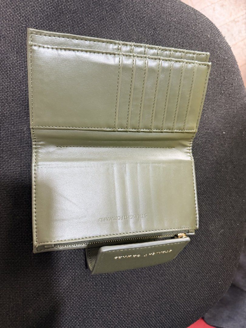 Straightforward Olive Green Tri-Fold Wallet (Category: Wallets & Card holders) located in Quezon City. Submitted by forever_chic (Listing ID 1453291730, Image 3). Description: Straight Forward DVL HESTIA wallet RFS: Not using Minor flaw: check photo natanggal ung letters What you is what you get Actual photo posted - Stylish olive green tri-fold wallet - Multiple card slots and clear ID window - Secure zippered coin compartment - Elegant gold har