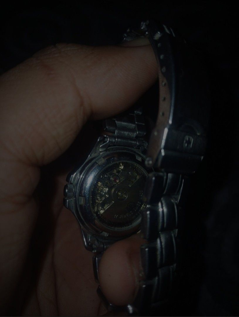 Swiss Military 100M Automatic Diver-Style Watch (Category: Men's Watches) located in Batac City. Submitted by silvercrystal_fd03a9 (Listing ID 1453395979, Image 2). Description: Vintage Swiss Military automatic watch featuring a dark black dial, luminous indices, date window at 3 o'clock, and a two-tone accent bezel with stainless steel bracelet. Classic rugged military design built for daily wear. ​Brand: Swiss Military ​Movement: Automatic ​Wat