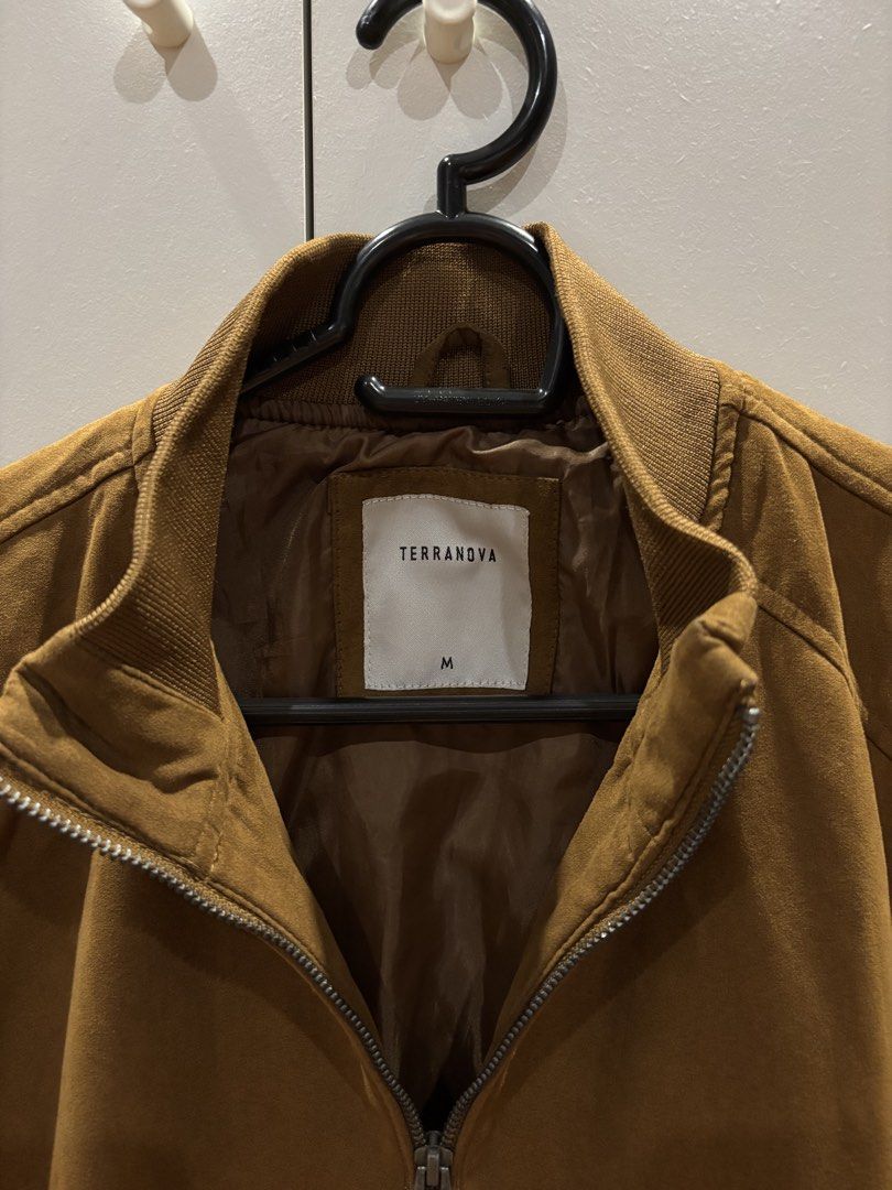 TERRANOVA Bomber Jacket Tan color Size M (Category: Coats, Jackets and Outerwear) located in Quezon City. Submitted by aaron.declutters (Listing ID 1453397845, Image 3). Description: - Brand: Terranova - Style: Brown/Tan Bomber Jacket - Size: Medium (M) - Features: Zip-up front, two side zip pockets - Details: Ribbed collar, cuffs, and hem - Material: Suede-like texture - Occasion: Ideal for casual wear.
