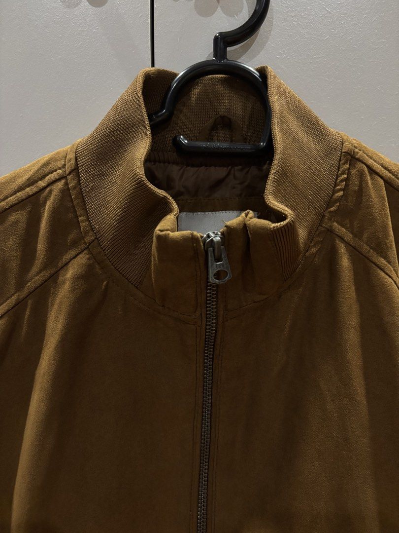 TERRANOVA Bomber Jacket Tan color Size M (Category: Coats, Jackets and Outerwear) located in Quezon City. Submitted by aaron.declutters (Listing ID 1453397845, Image 2). Description: - Brand: Terranova - Style: Brown/Tan Bomber Jacket - Size: Medium (M) - Features: Zip-up front, two side zip pockets - Details: Ribbed collar, cuffs, and hem - Material: Suede-like texture - Occasion: Ideal for casual wear.
