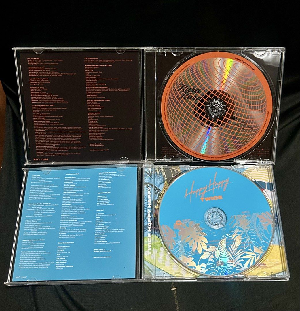 TWICE Japanese CD albums (Category: CDs & DVDs) located in Tanza. Submitted by mayapellazar (Listing ID 1453368238, Image 3). Description: PRE - OWNED The top-left jewel case is TWICE’s 9th Japanese single, “Doughnut”, which was released in December 2021. It stands out as their first winter ballad-focused single title, featuring a snowy forest backdrop. The top-right case contains their 8th Japanese single, “Kura Kura”, released in May 2021. The 