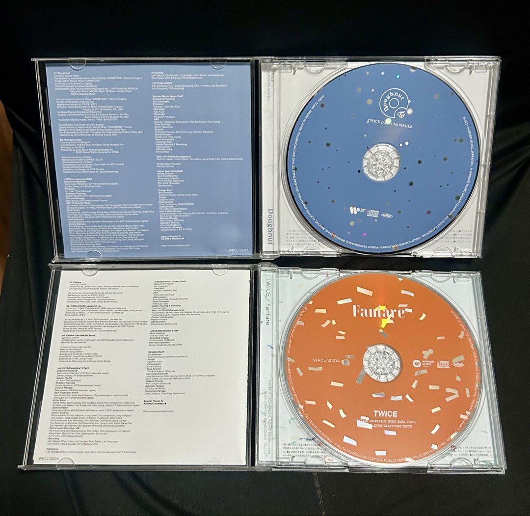TWICE Japanese CD albums (Category: CDs & DVDs) located in Tanza. Submitted by mayapellazar (Listing ID 1453368238, Image 2). Description: PRE - OWNED The top-left jewel case is TWICE’s 9th Japanese single, “Doughnut”, which was released in December 2021. It stands out as their first winter ballad-focused single title, featuring a snowy forest backdrop. The top-right case contains their 8th Japanese single, “Kura Kura”, released in May 2021. The 