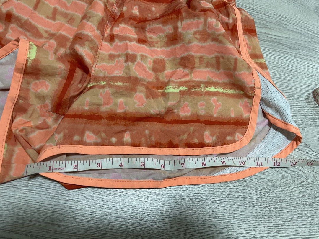 Under Armour Orange Running Shorts Tie-Dye Print (Category: Activewear) located in Pasig City. Submitted by gigiera (Listing ID 1453364796, Image 3). Description: - Eye-catching tie-dye print in orange, pink, and yellow - Authentic Under Armour running shorts - Comfortable elastic waistband with adjustable drawstring - Mesh side panels for enhanced breathability - Versatile for intense workouts or casual, stylish wear.
