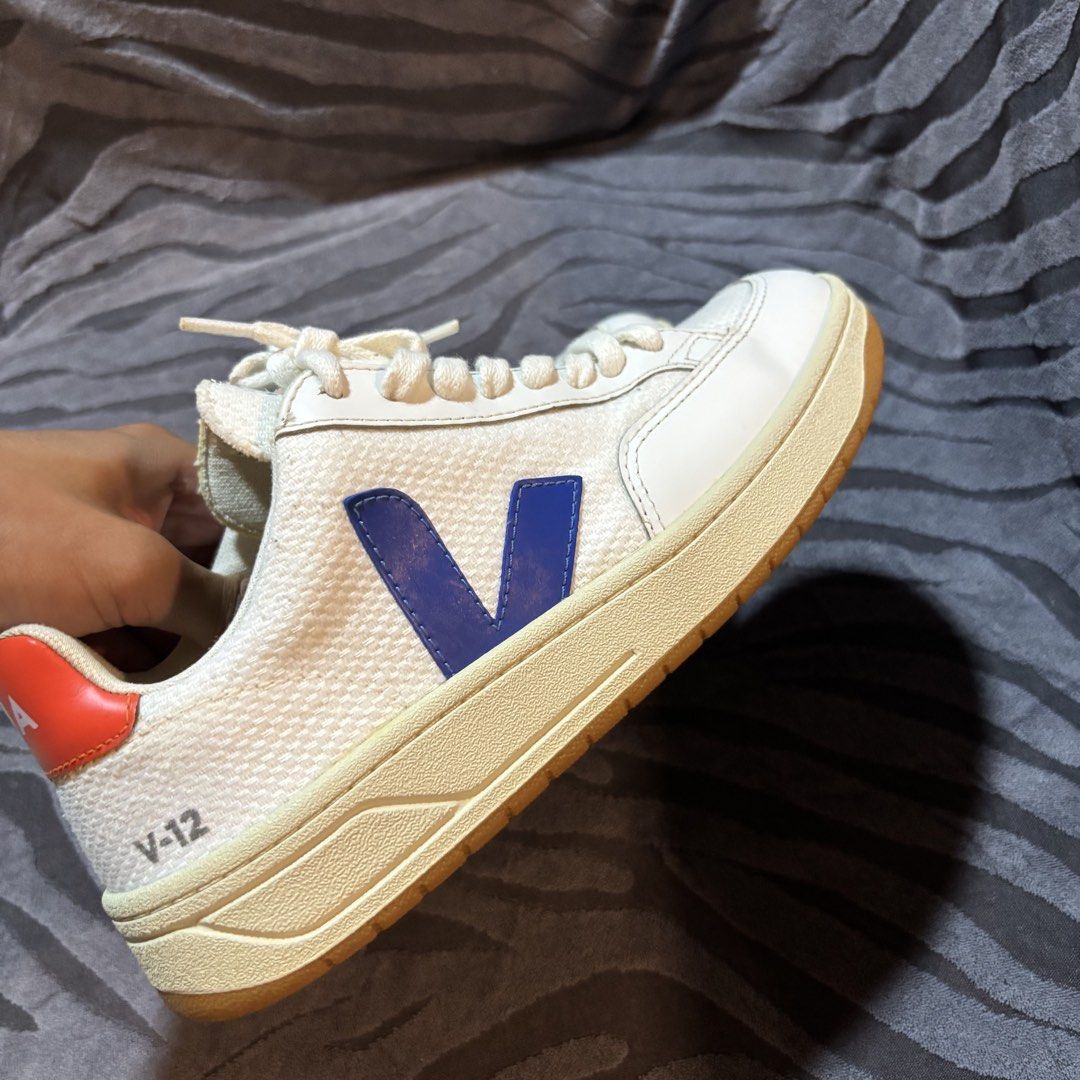 Veja V-12 Sneakers White Blue Orange (Category: Sneakers) located in Dipolog. Submitted by dionato (Listing ID 1453415445, Image 2). Description: - White Veja V-12 sneakers - Iconic blue V logo - Contrasting orange heel tab - Durable gum sole - Classic and versatile style - Ideal for everyday wear - Please check photos for detailed condition.