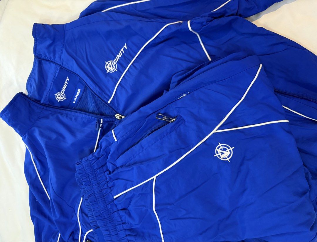 Vicinity Blue Tracksuit Set (Category: Sets & Coordinates) located in Cavite. Submitted by clienmusic67771 (Listing ID 1453329561, Image 3). Description: Blue Vicinity Tracksuit Set Size Large Details: - 100% NYLON - WATERPROOF FABRIC - VICINITY EMBROIDERIES AT FRONT AND BACK - WHITE PIPING - ADJUSTABLE WAISTBAND - ZIPPER POCKETS - INSIDE MESH LINING - V-LOGO ZIPPER PULLER - INSIDE POCKET ON THE LEFT - VICINITY TAG ON THE LEFT .