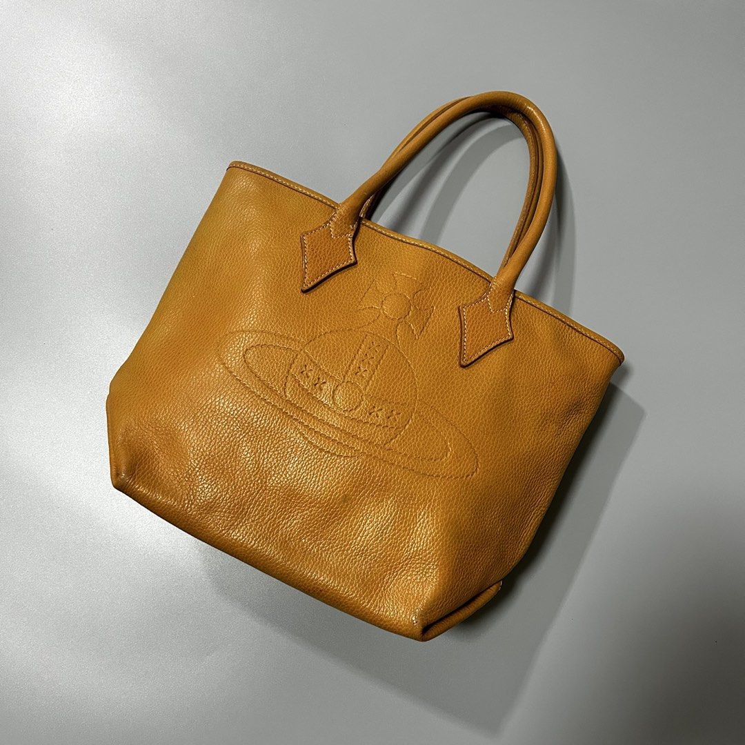 Vivienne Westwood Leather Tote Bag (Authentic) (Category: Luxury Bags & Wallets) located in Pandi. Submitted by davidsorianooo917 (Listing ID 1453393231, Image 1). Description: Vivienne Westwood Leather Tote Bag This Vivienne Westwood Leather Tote is an authentic, vintage piece crafted from grained leather. It features the brand’s iconic embossed orb logo prominently displayed on the front, accompanied by sturdy dual top handles and pointed leath