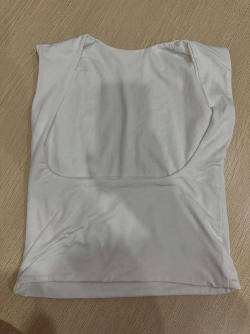 White Boat Neck Backless Top (Category: Sleeveless) located in Manila. Submitted by nielas.closet (Listing ID 1453331808, Image 2). Description: - Basic white tank top - Sleeveless design - Stretchy material for comfort - Perfect for layering or wearing on its own - Simple and versatile wardrobe essential - Easy to pair with any outfit.