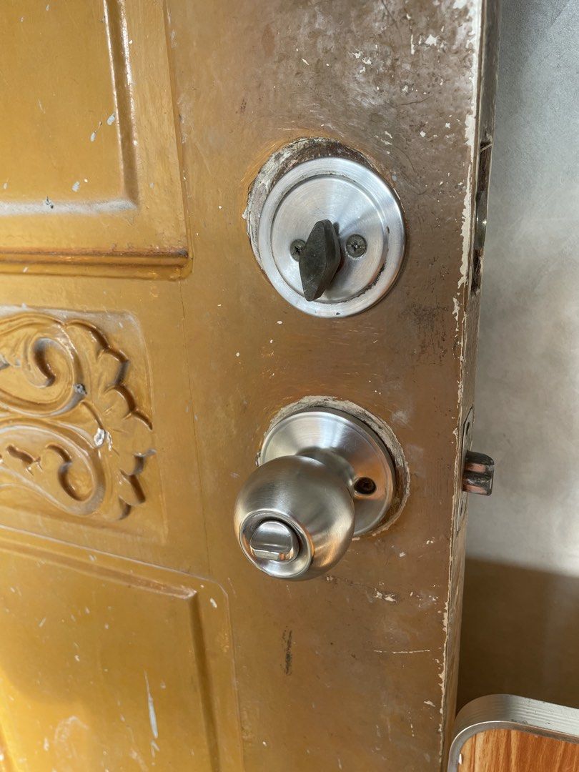 Wooden Door with Lockset and Handle (Category: Locks, Doors & Gates) located in Manila. Submitted by malyniphon86147 (Listing ID 1453408973, Image 2). Description: - Solid wooden door - Attractive yellow-brown paint finish - Four distinct panels - Decorative carving on the middle section - Includes lockset and doorknob - Shows some signs of wear and tear (paint and edges) - Ready for immediate use or a creative renovation project.
