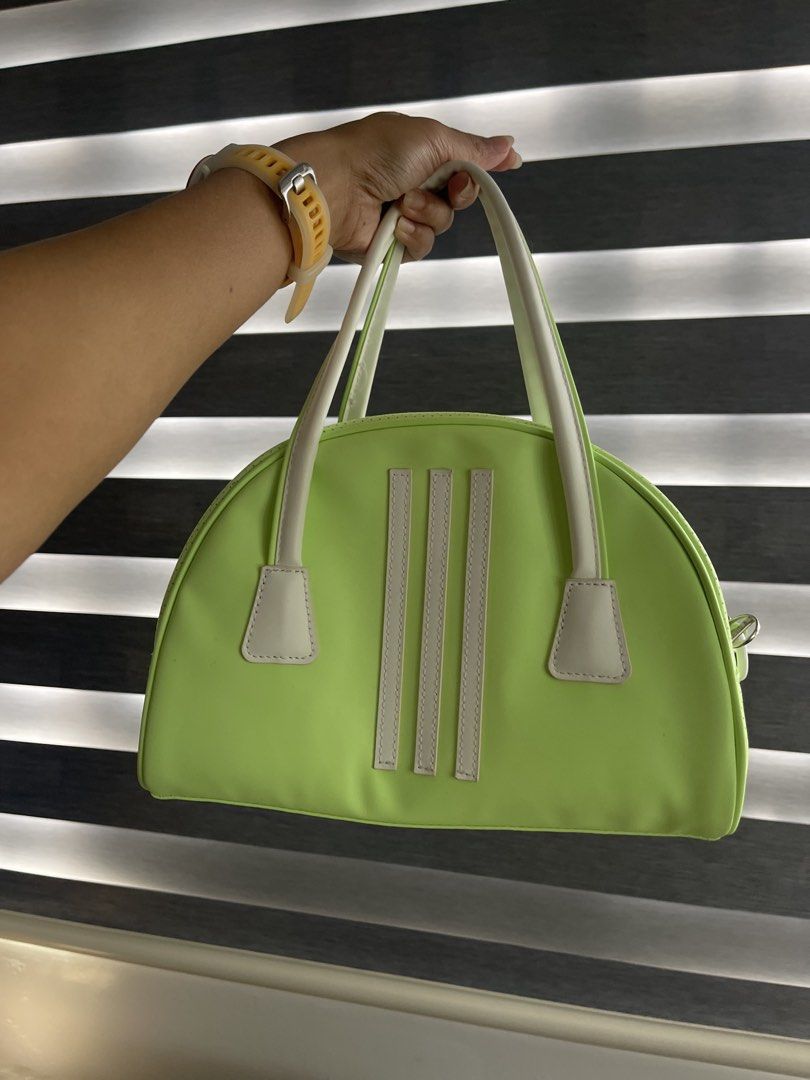 Adidas Lime Green Golf Bag (Category: Purses & Pouches) located in San Pablo. Submitted by cintahandmade (Listing ID 1456660176, Image 1). Description: LIKE NEW (used once pauwi sa Pinas lang, bought in SG 🇸🇬) - Cute lime green Adidas golf bag - Classic three stripes on one side - Trefoil logo on the other side - Perforated texture on the sides - White handles and trim - Zipper closure with Adidas branded zipper pull - Great for carrying essent