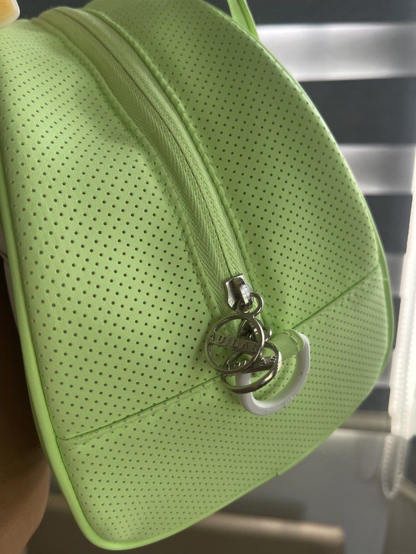 Adidas Lime Green Golf Bag (Category: Purses & Pouches) located in San Pablo. Submitted by cintahandmade (Listing ID 1456660176, Image 3). Description: LIKE NEW (used once pauwi sa Pinas lang, bought in SG 🇸🇬) - Cute lime green Adidas golf bag - Classic three stripes on one side - Trefoil logo on the other side - Perforated texture on the sides - White handles and trim - Zipper closure with Adidas branded zipper pull - Great for carrying essent
