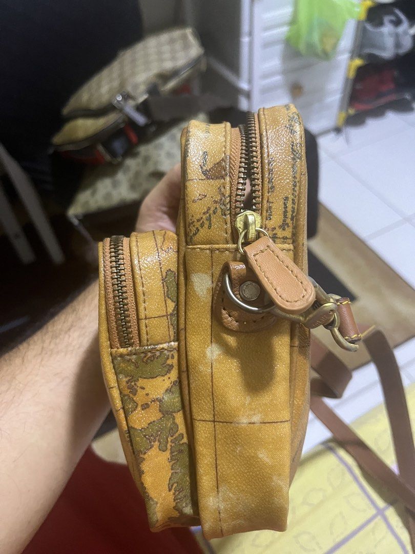Alviero Martini Geo Map Crossbody Bag (Category: Luxury Bags & Wallets) located in Manila. Submitted by jankbaiteh05162 (Listing ID 1456624296, Image 3). Description: - Authentic Alviero Martini crossbody bag - Iconic geo map print - Genuine leather trim and strap - Two zippered compartments for organization - Gold-tone hardware - Adjustable strap for comfortable wear Slight issue sa harap pa check ng pic.